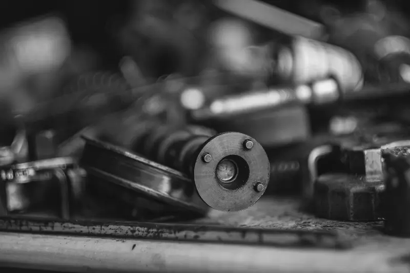 Vehicle parts on a workbench, blurred towards the back